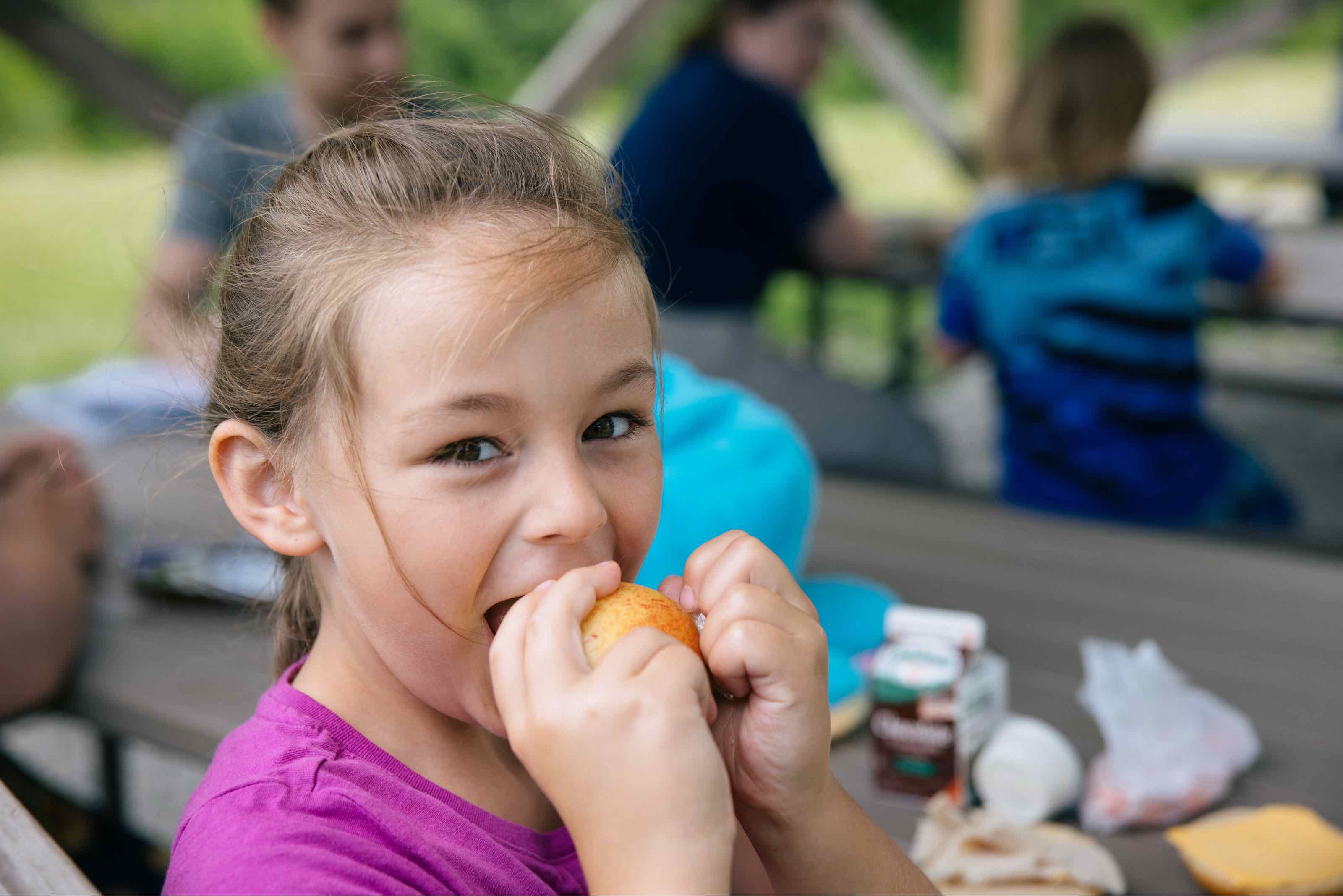 Close up of a girl eating an apple